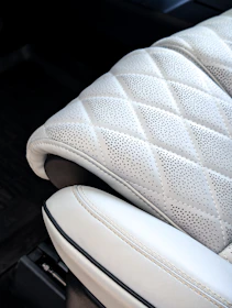 White quilted perforated car seat interior.