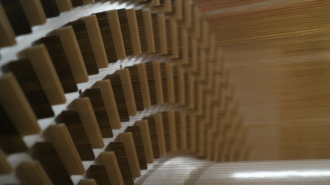 Close detail of curved machined turbine blades, shot in cool grey tones