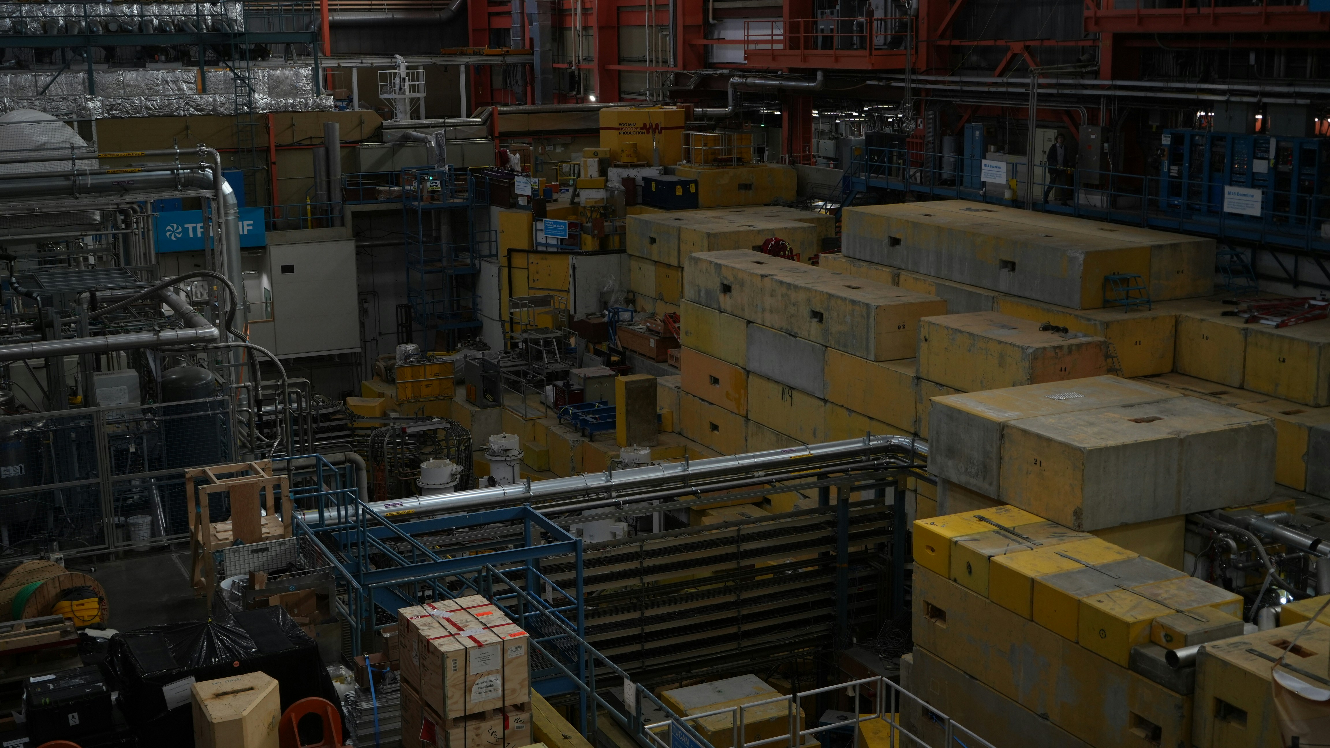 A cluttered industrial facility with numerous boxes and machinery.