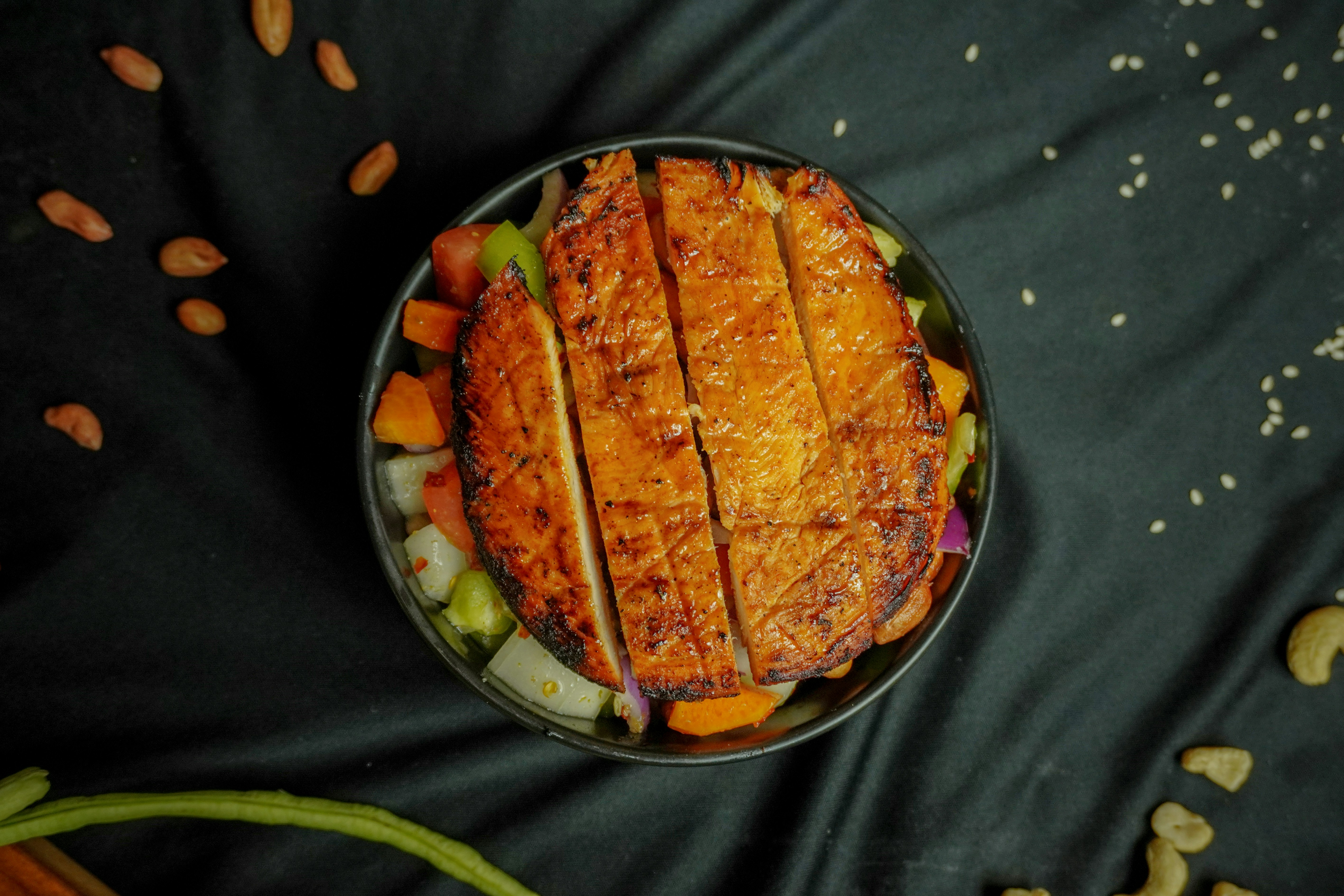 A vibrant fresh salad bowl overflowing with colorful vegetables leafy greens and a visible lean protein source e g grill
