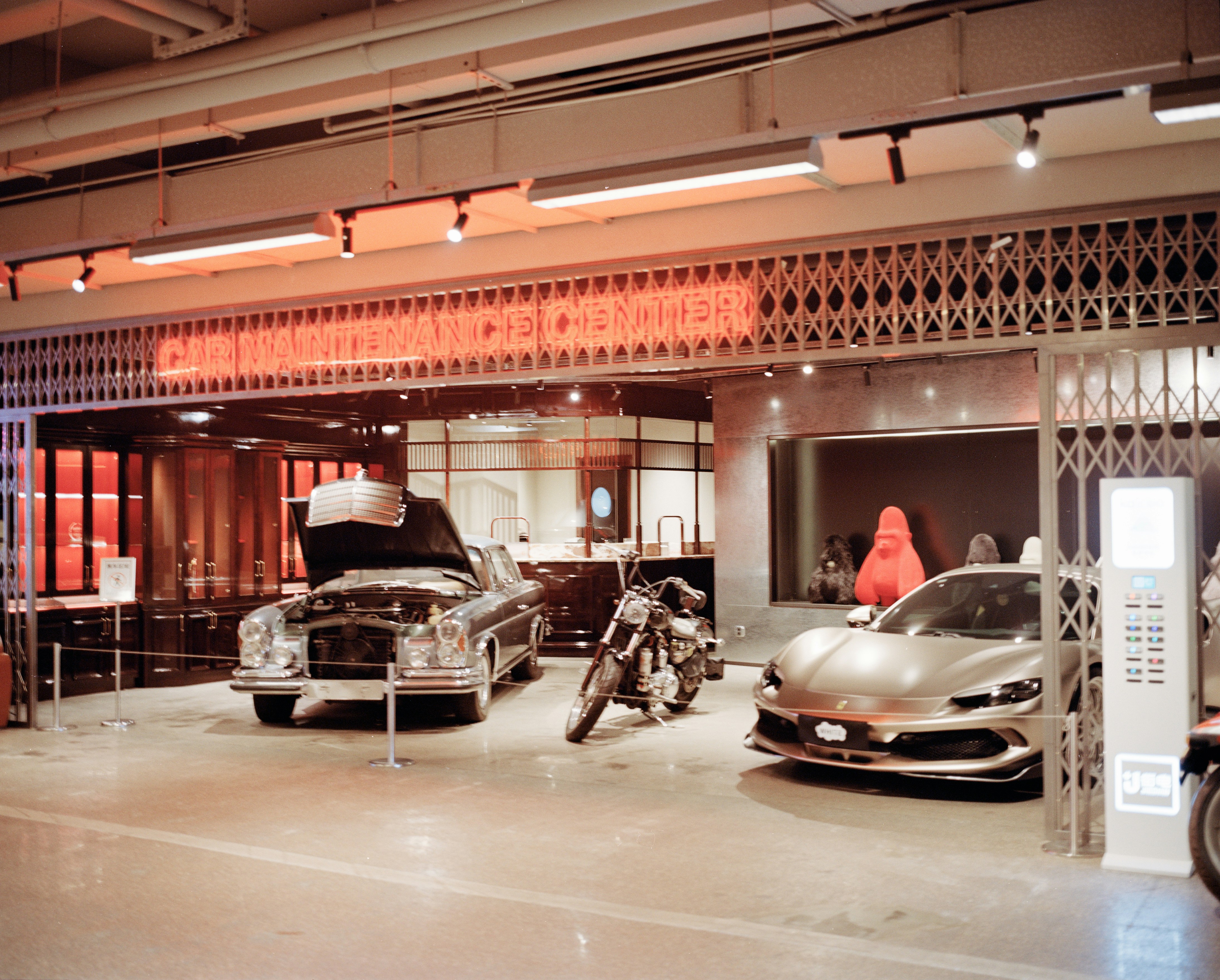 Classic and modern vehicles displayed in an indoor showroom