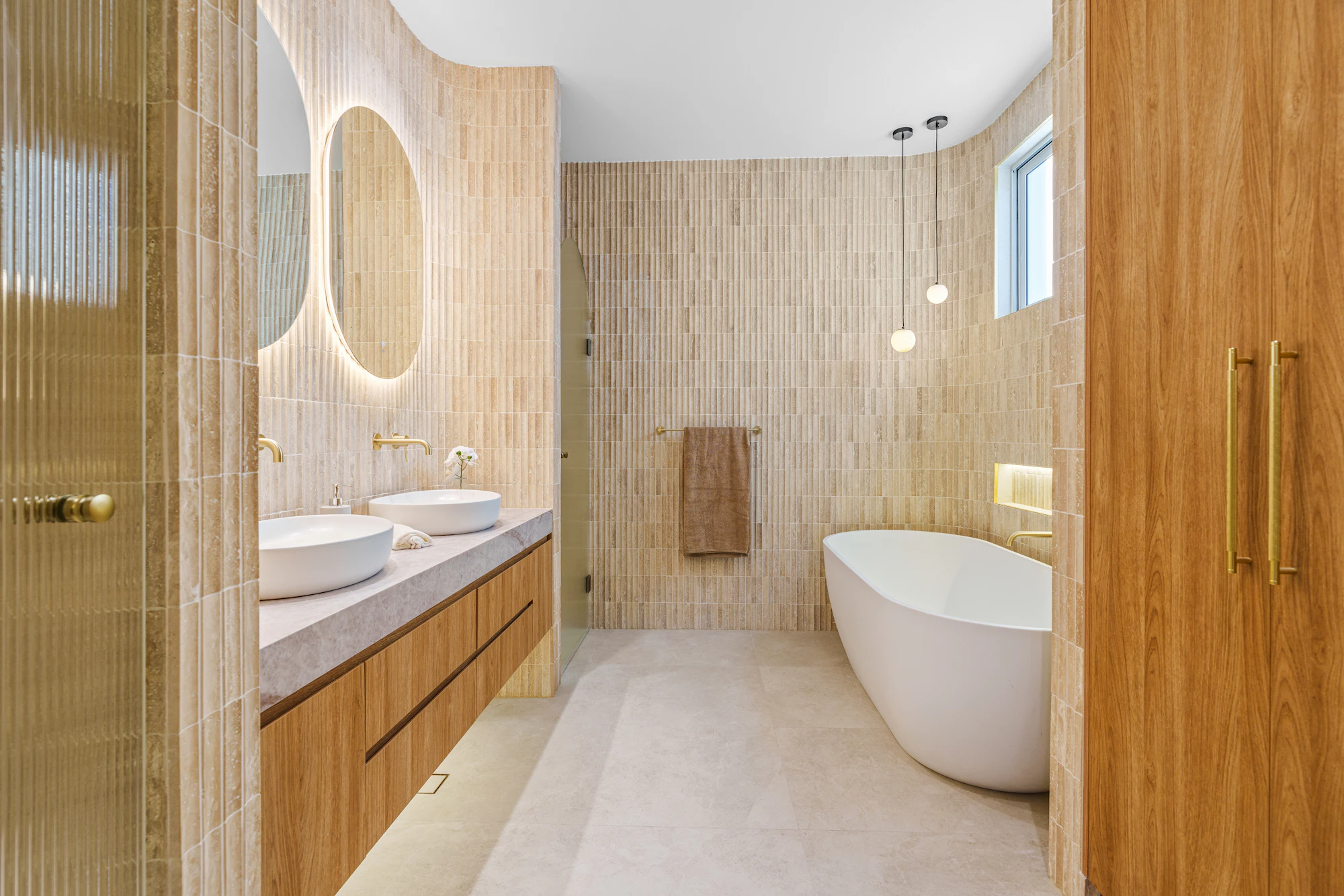 Travertine bathroom with bespoke oak vanity unit