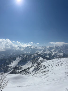 Vast snow-covered mountains bathed in bright sunlight
