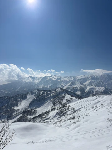 Vast snow-covered mountains bathed in bright sunlight.