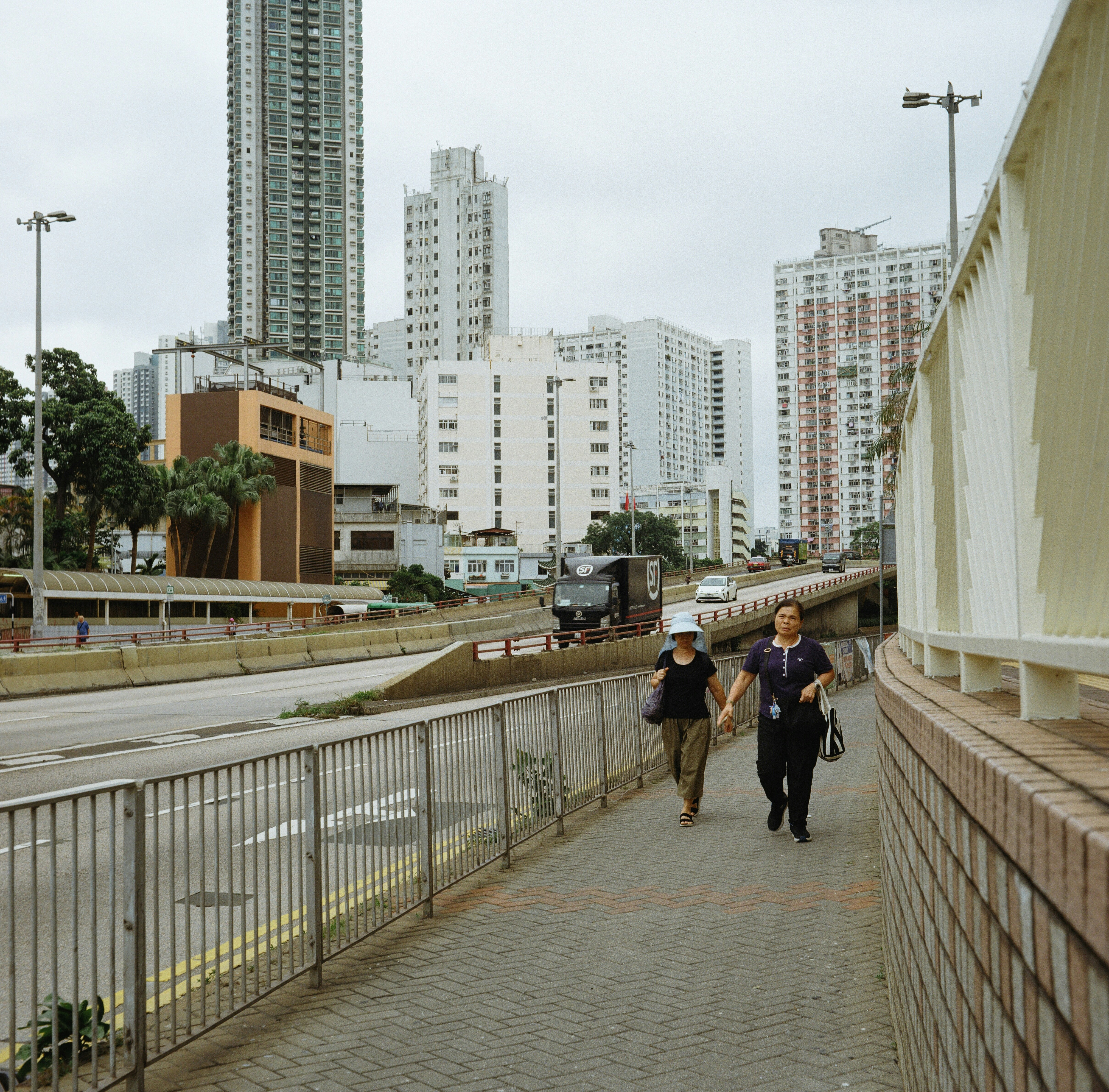 People walking on a sidewalk in a modern city.