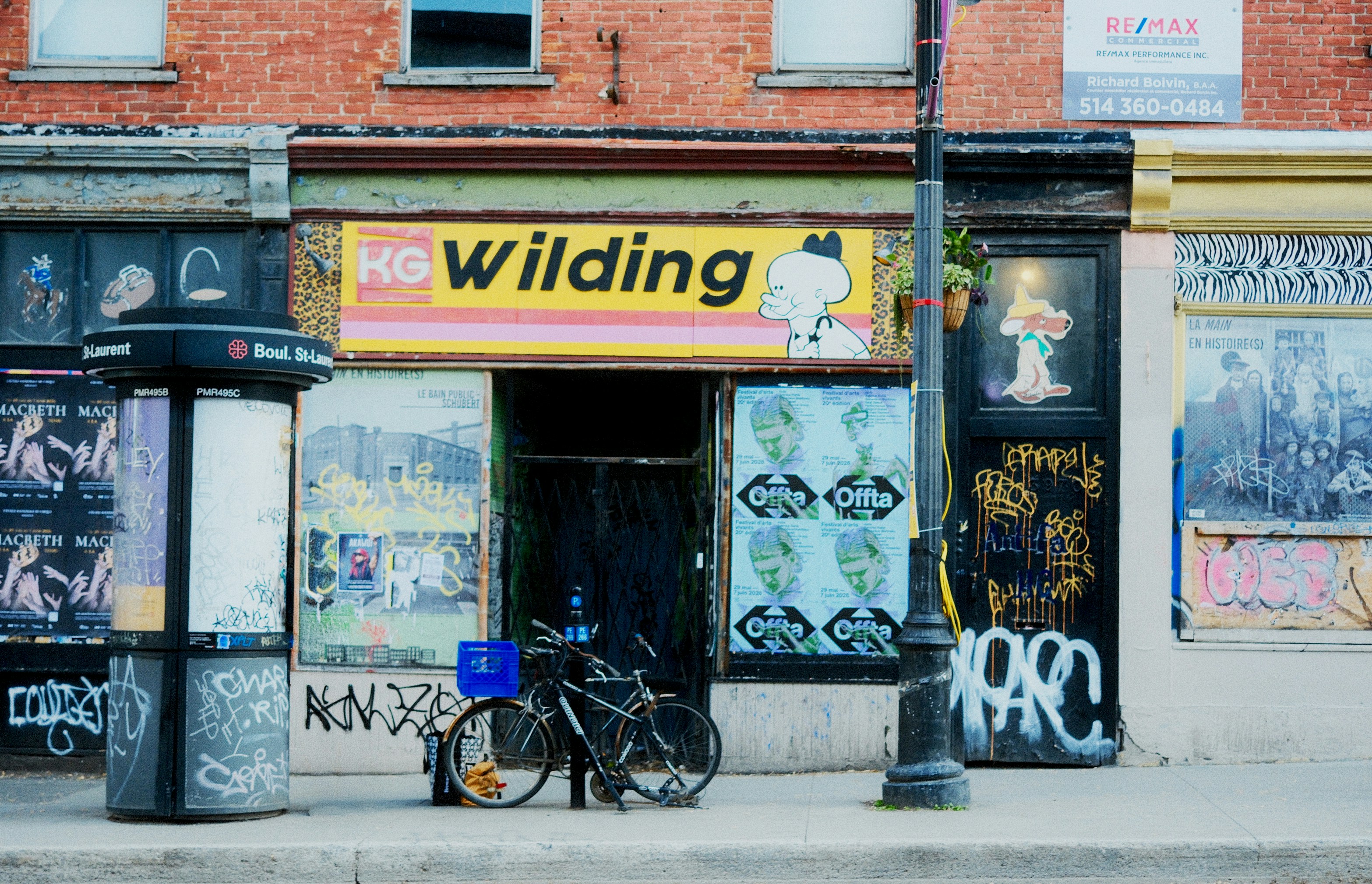 A street with old buildings, a bicycle, and graffiti.