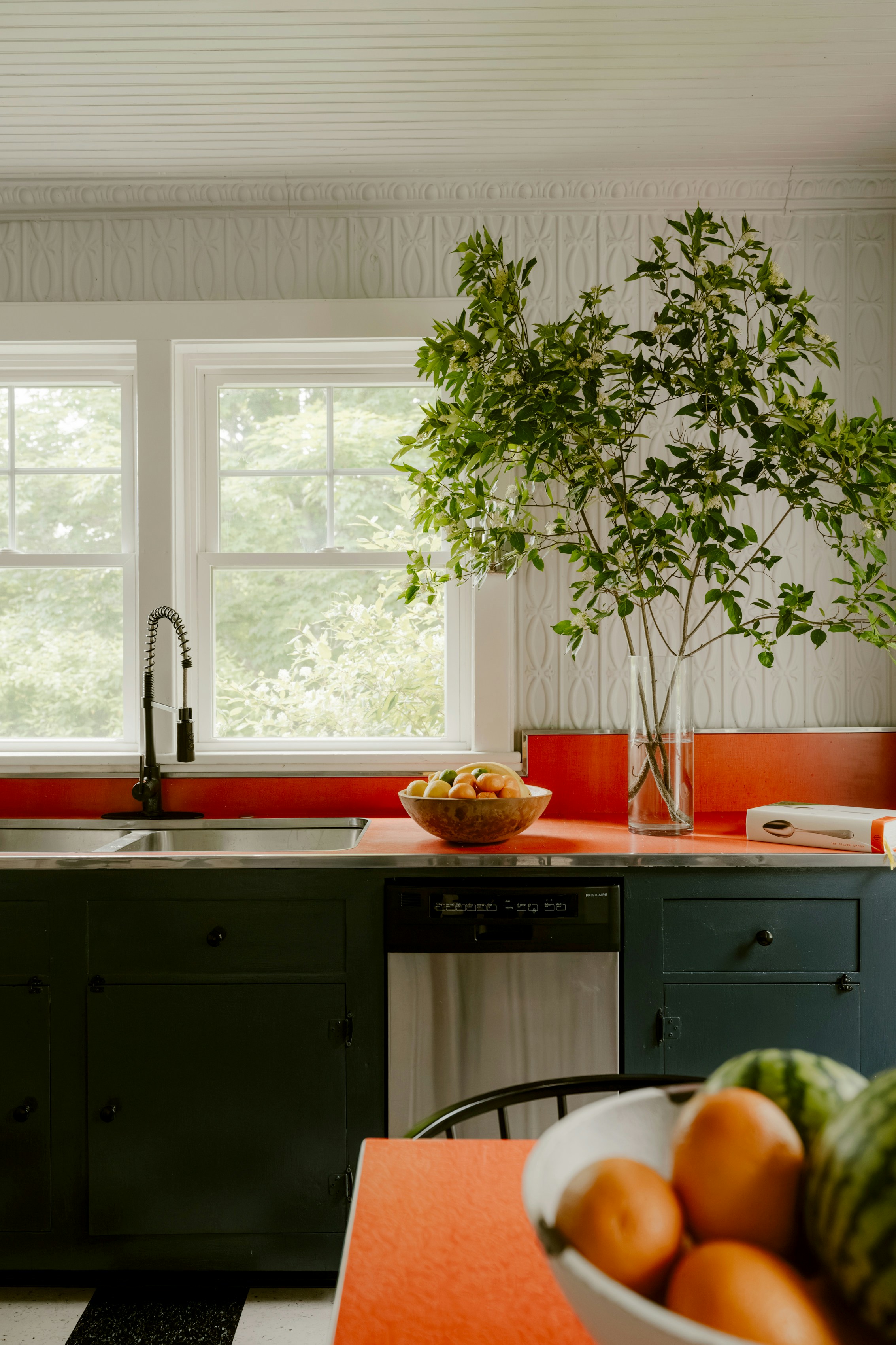 Stylish kitchen with dark painted cabinets and bold counter color