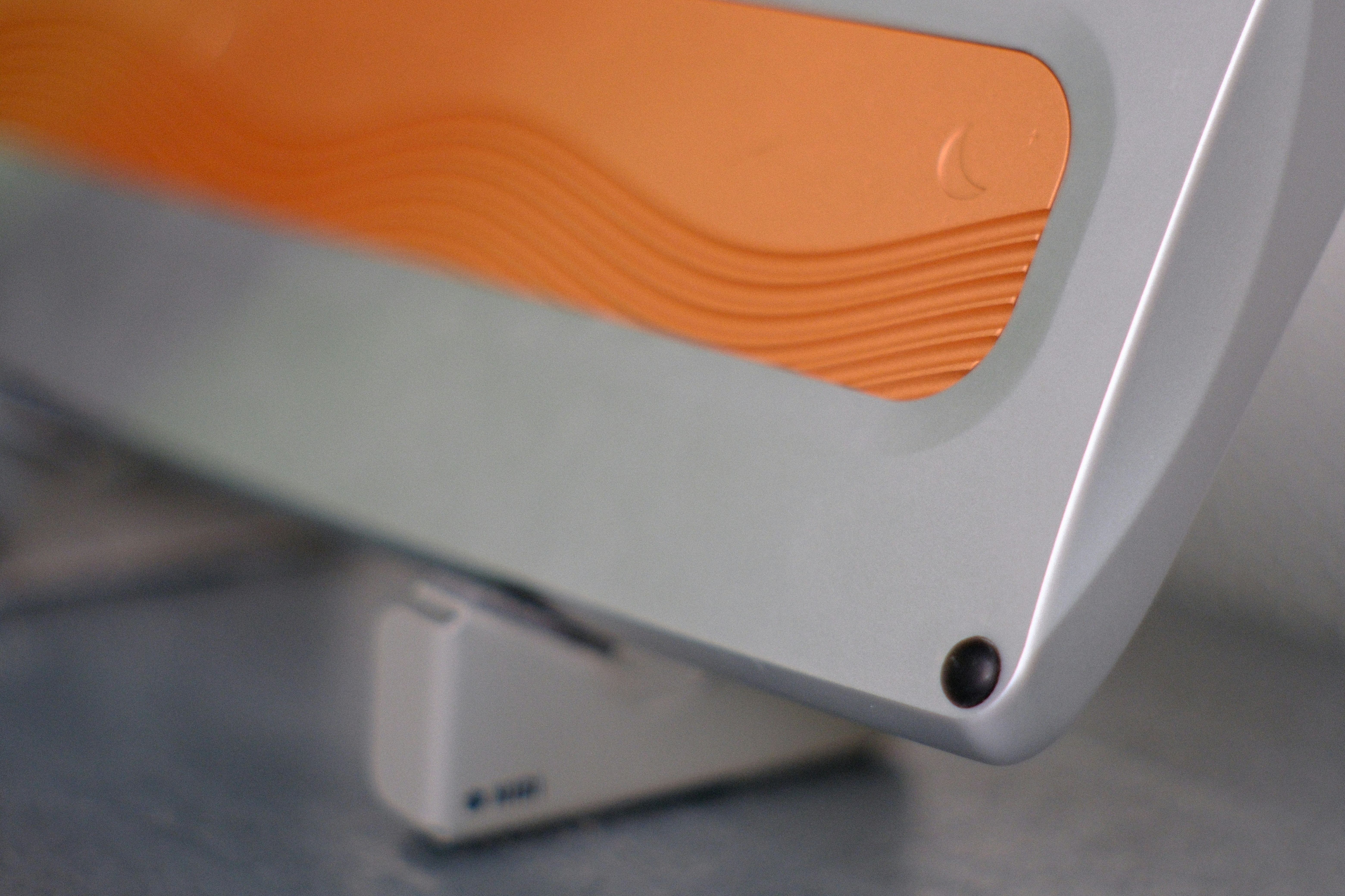 Orange textured surface on a grey object.