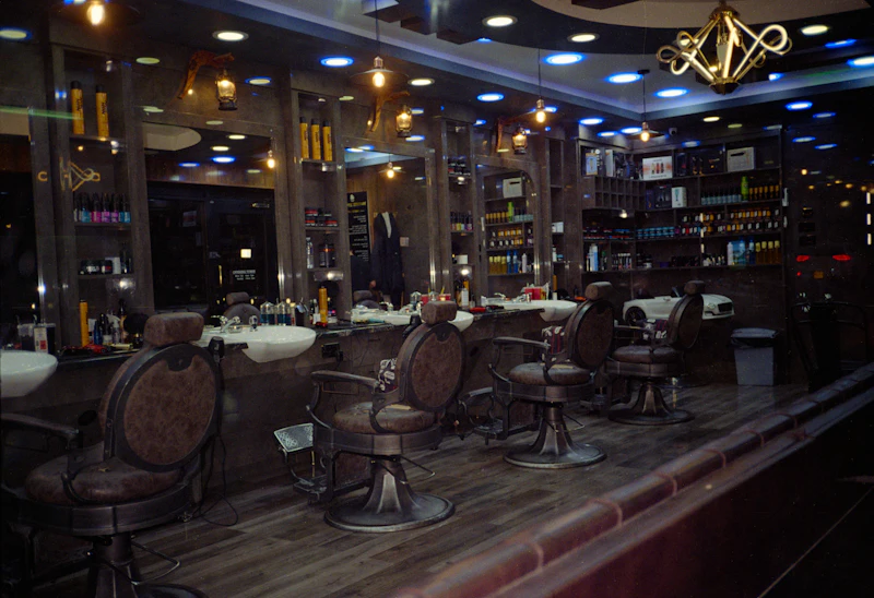 An empty barbershop with chairs and mirrors