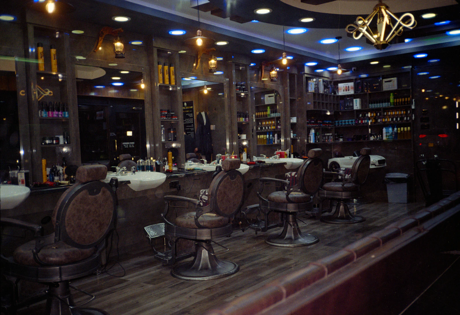 Empty leather barber chairs and mirrors inside Fade Theory Barber Co. in Duluth, GA