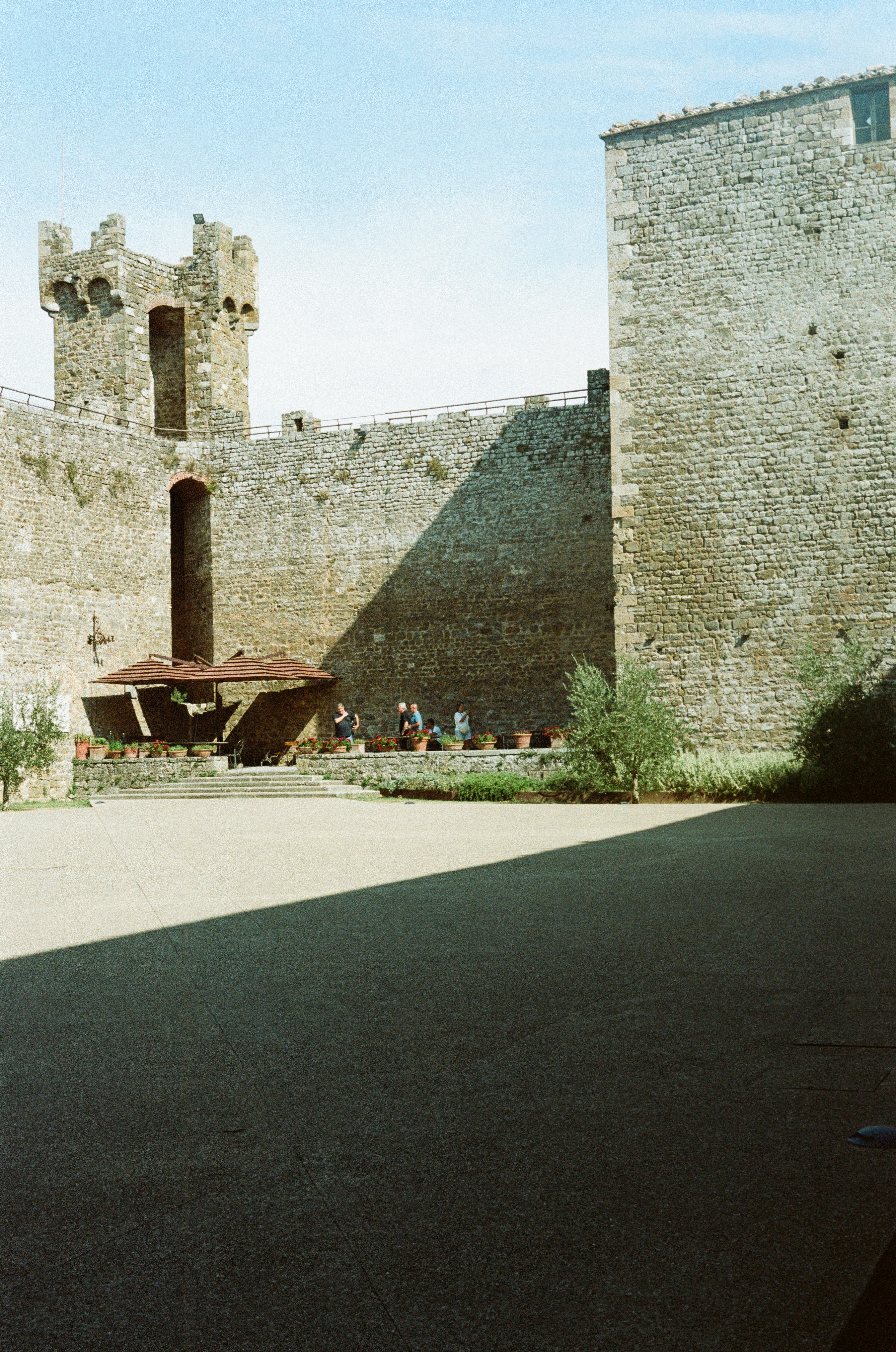 Historic stone castle courtyard under a bright sunny sky.