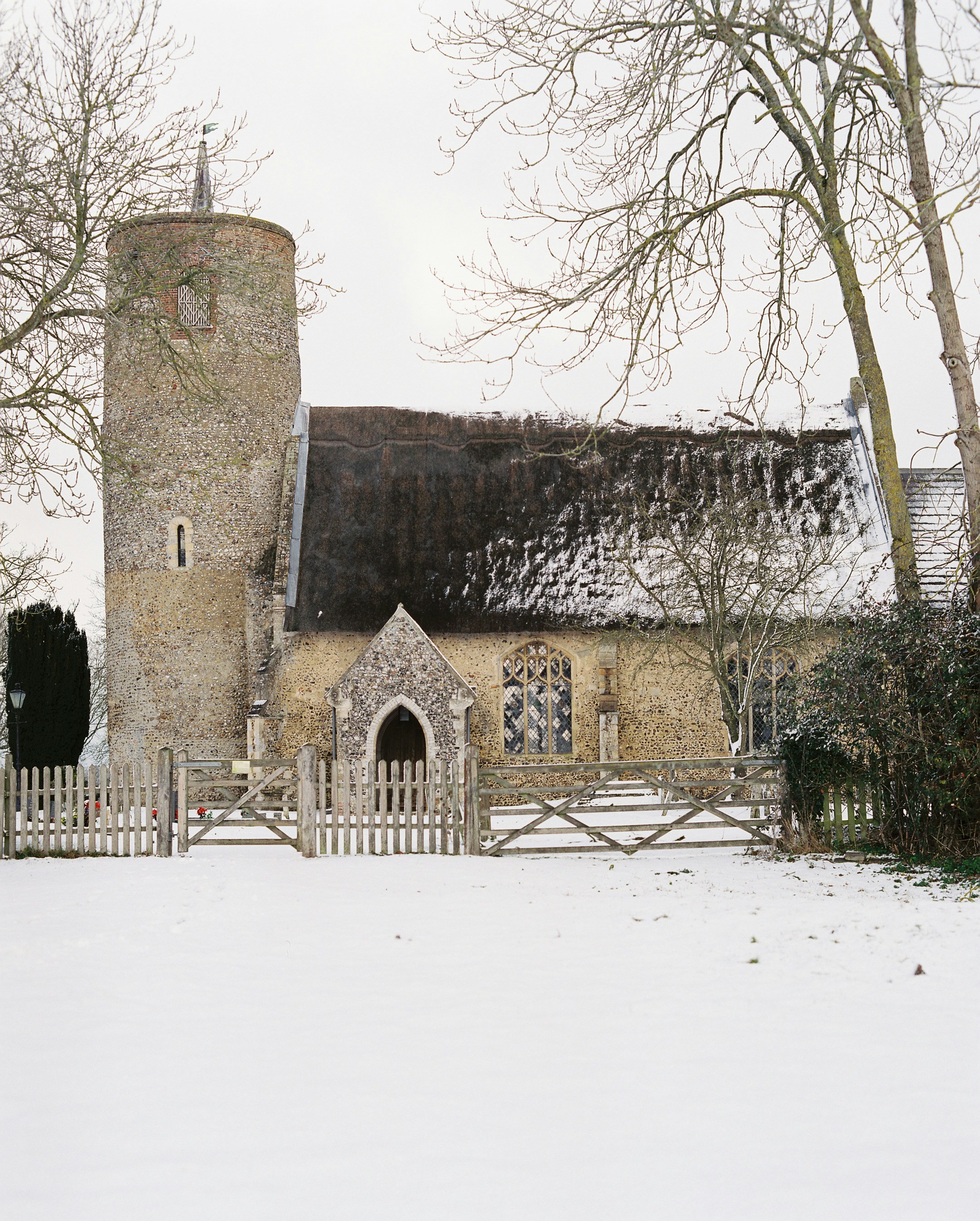 Round-towered church in fresh snow at Seething, Norfolk