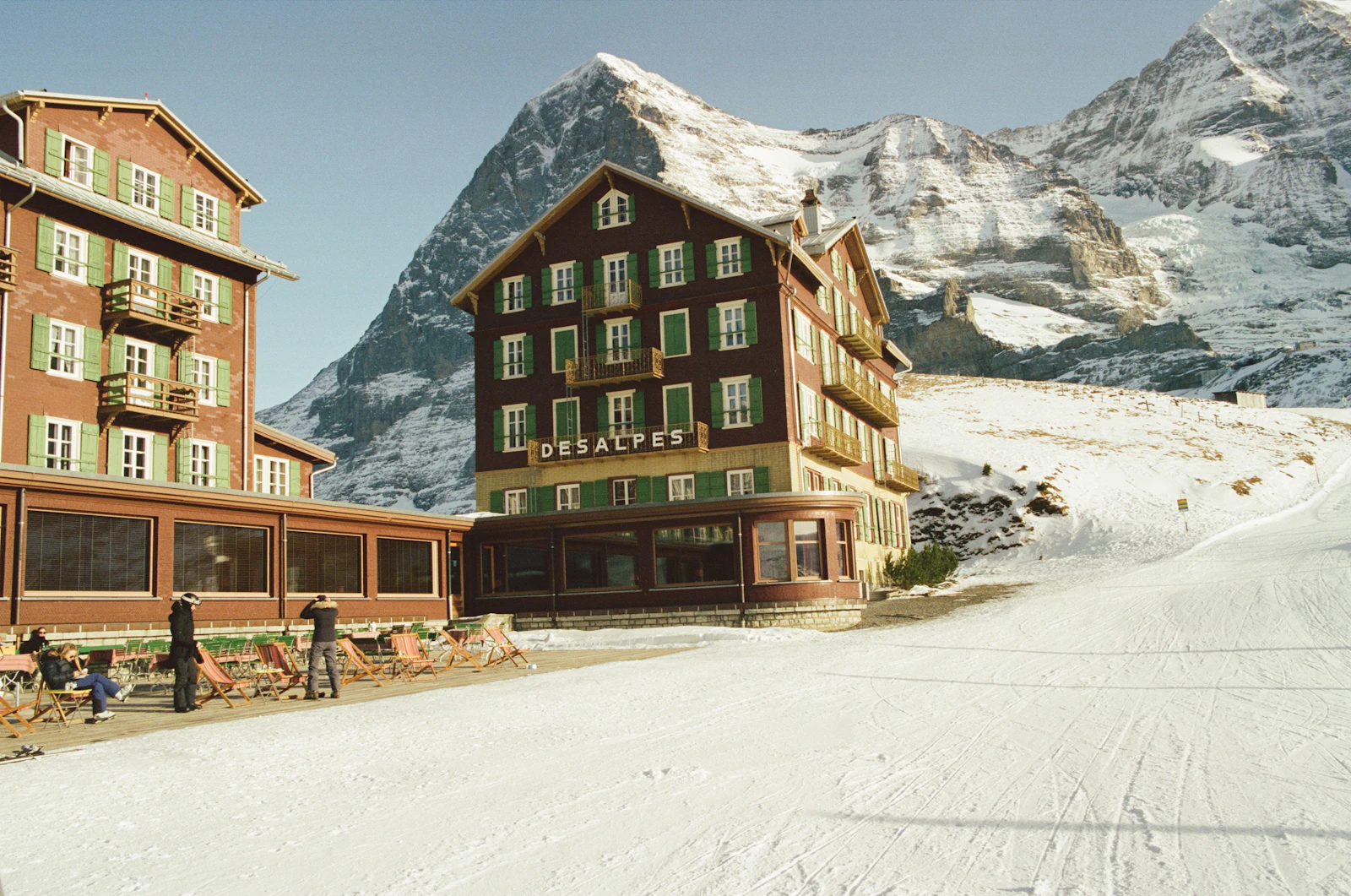 Wengen hotels beside a ski slope and snow-covered peaks in winter
