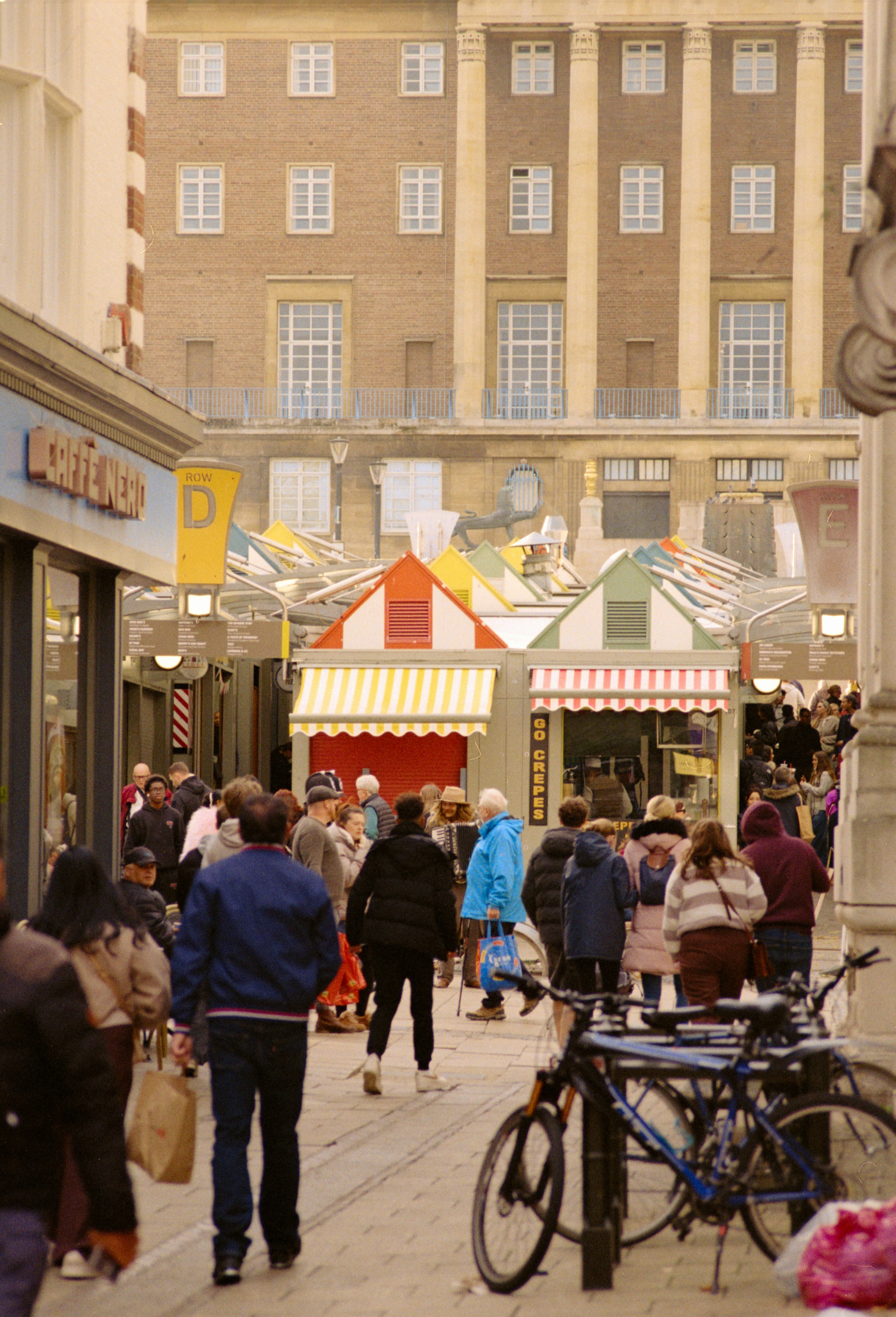 Busy Street Market with People and Colorful Stalls
