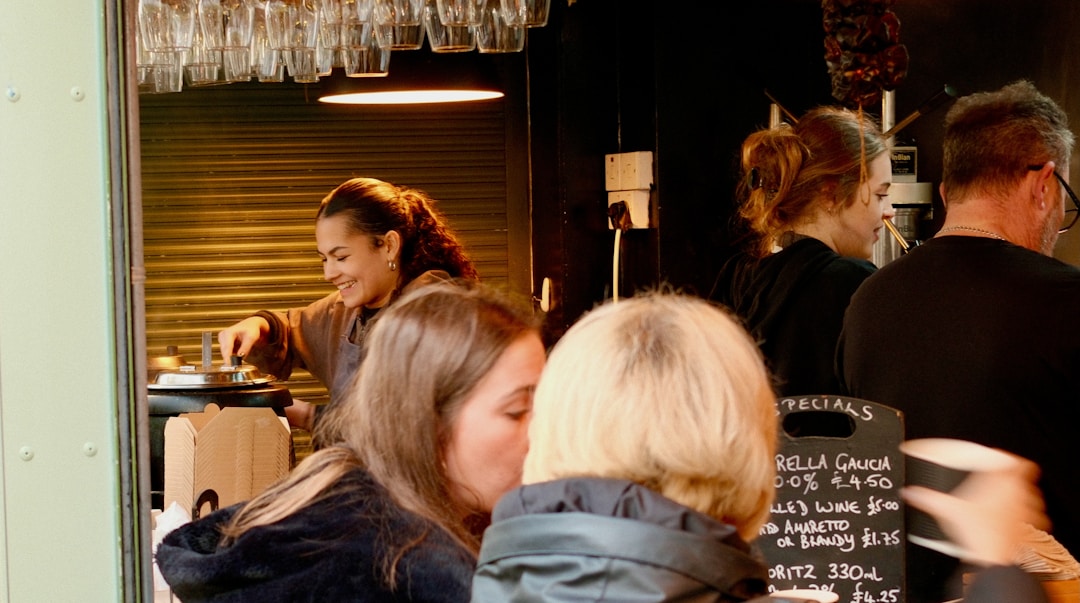 A small-business owner serving a customer at the counter