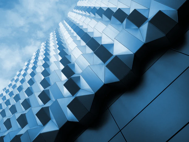Modern building with geometric facade against a blue sky