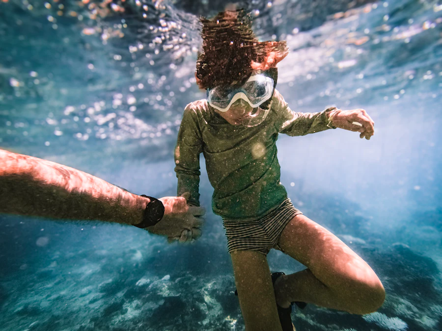 A child snorkeling in clear ocean water