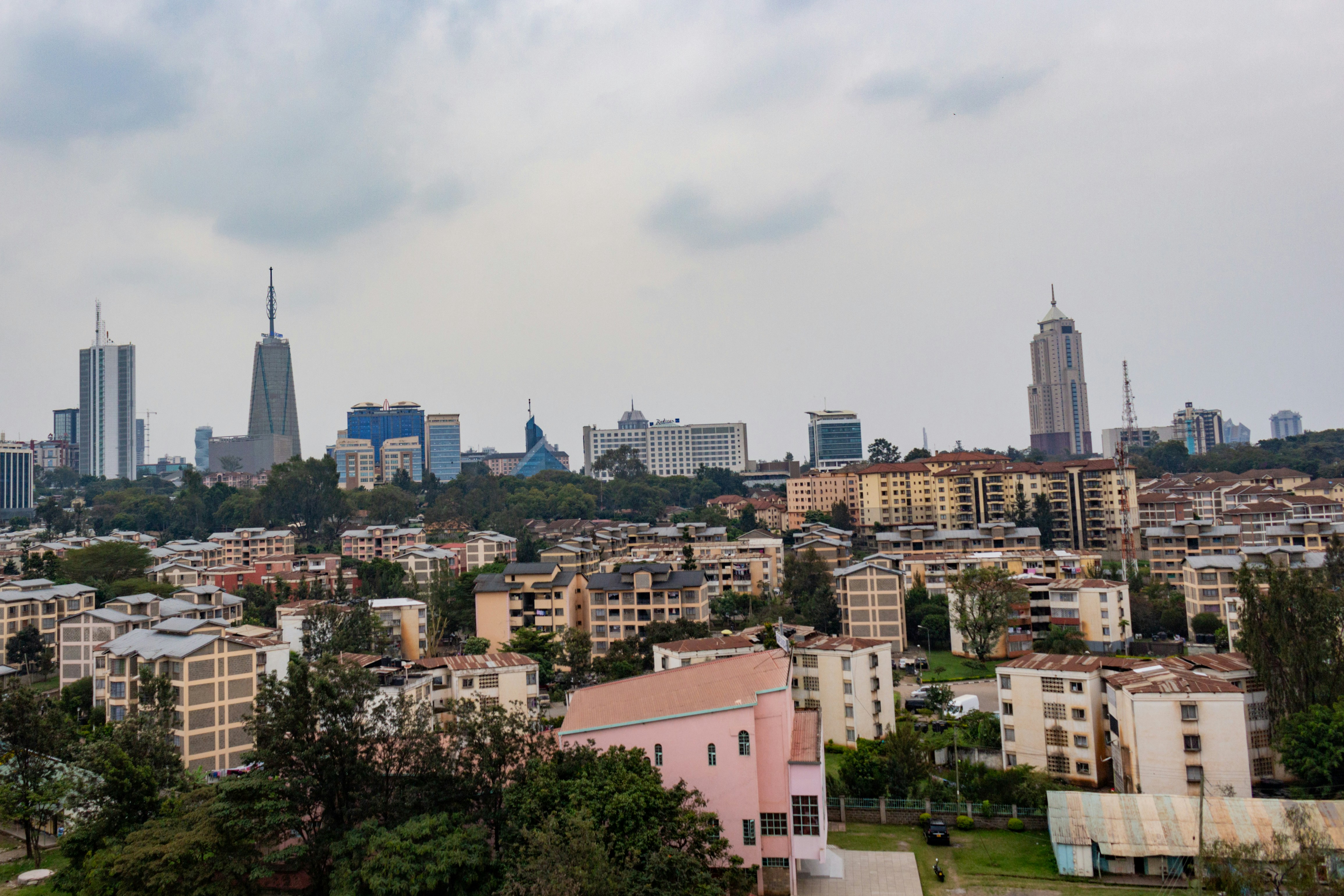 Cityscape with modern skyscrapers and dense residential buildings.