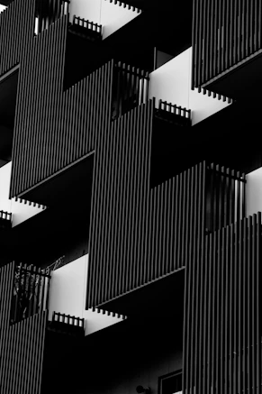 Black and white modern building facade with geometric patterns.