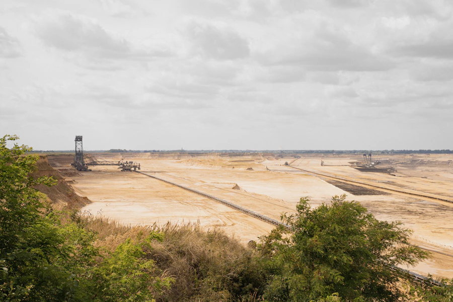 Large open-pit mining operation with conveyor and excavator