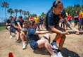 People vigorously compete in an outdoor tug-of-war game.