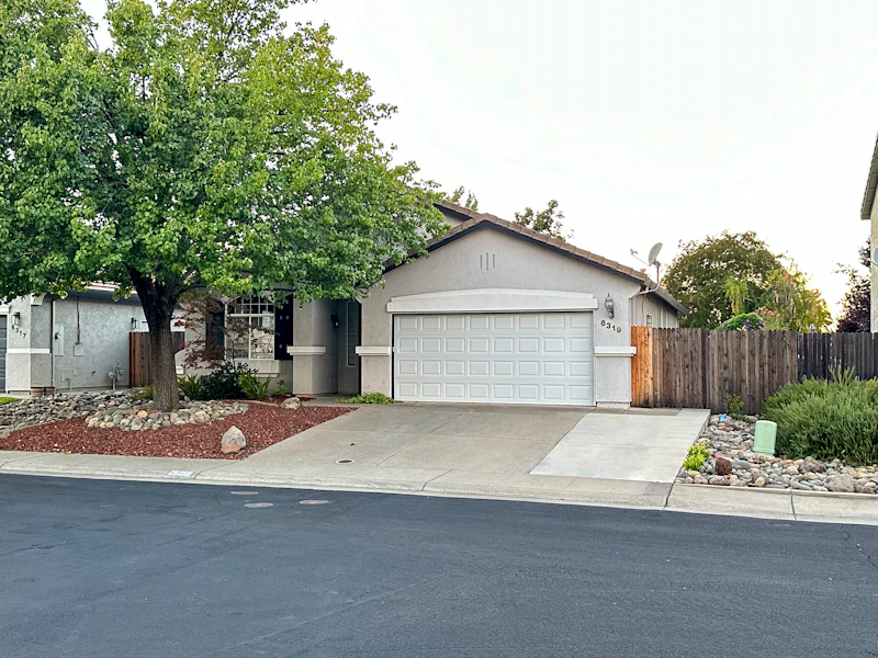 Single-story home with an attached two-car garage on a quiet street