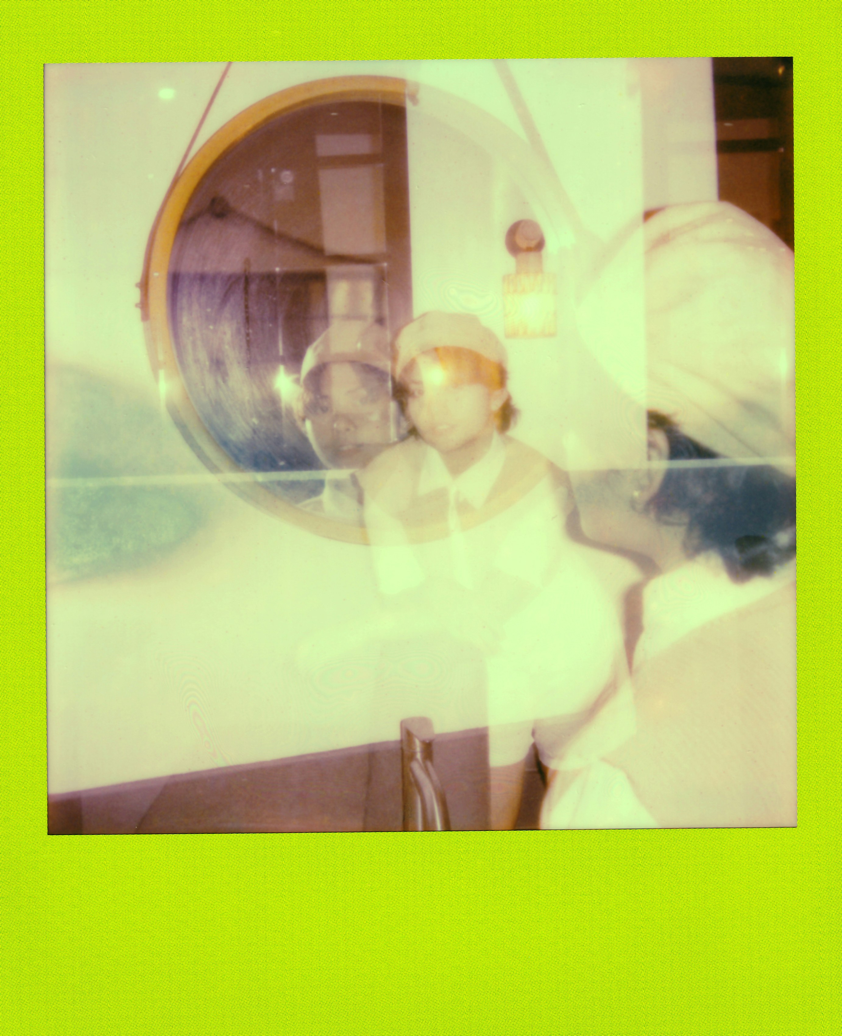 Blurry person and reflection in vintage instant film.