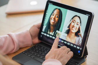 Editing video of two happy women on a digital tablet.