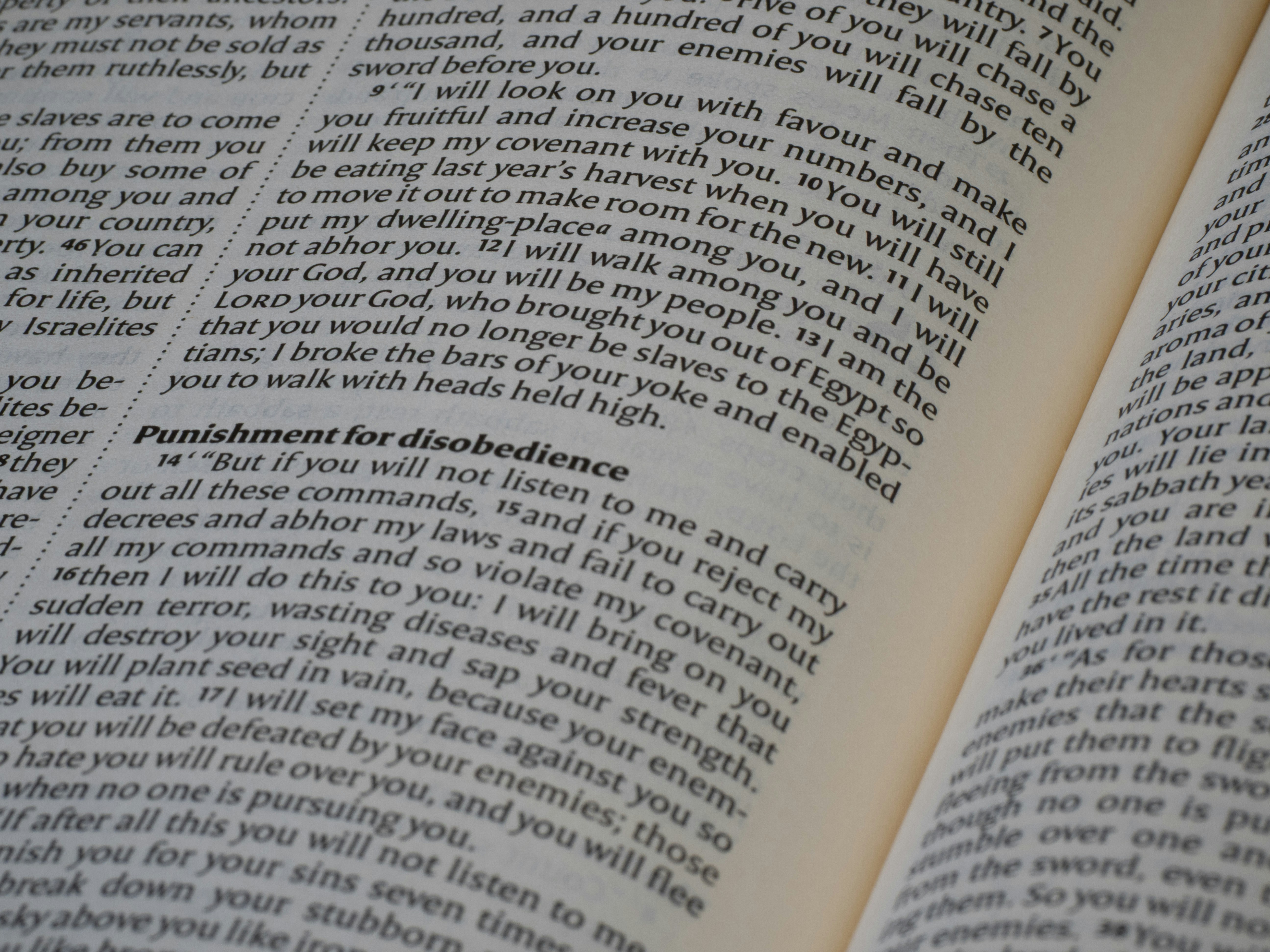 An open bible displaying text on its pages.