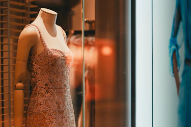 Pink lace dress on a mannequin in a shop window