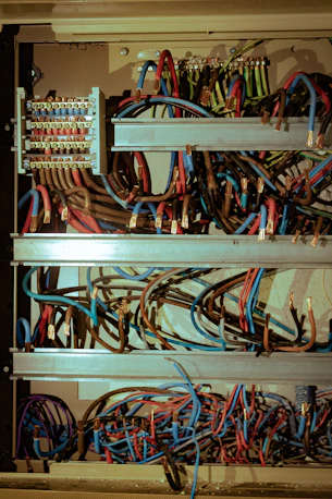 Colorful electrical wires and terminals inside an open panel.