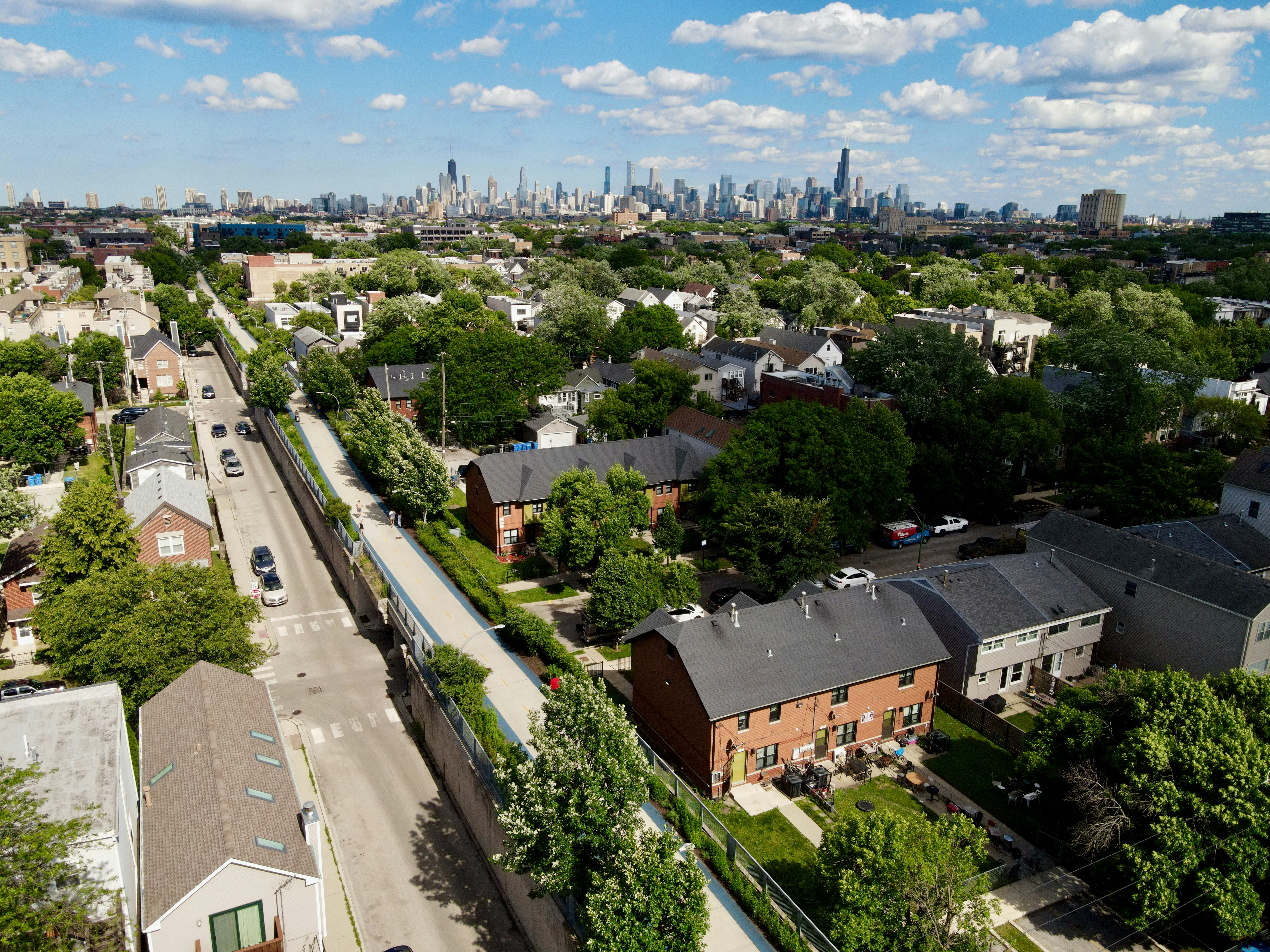 City skyline over residential area with elevated green path.