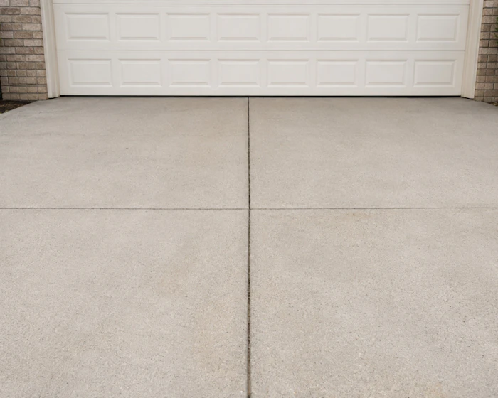 Concrete driveway in front of a garage