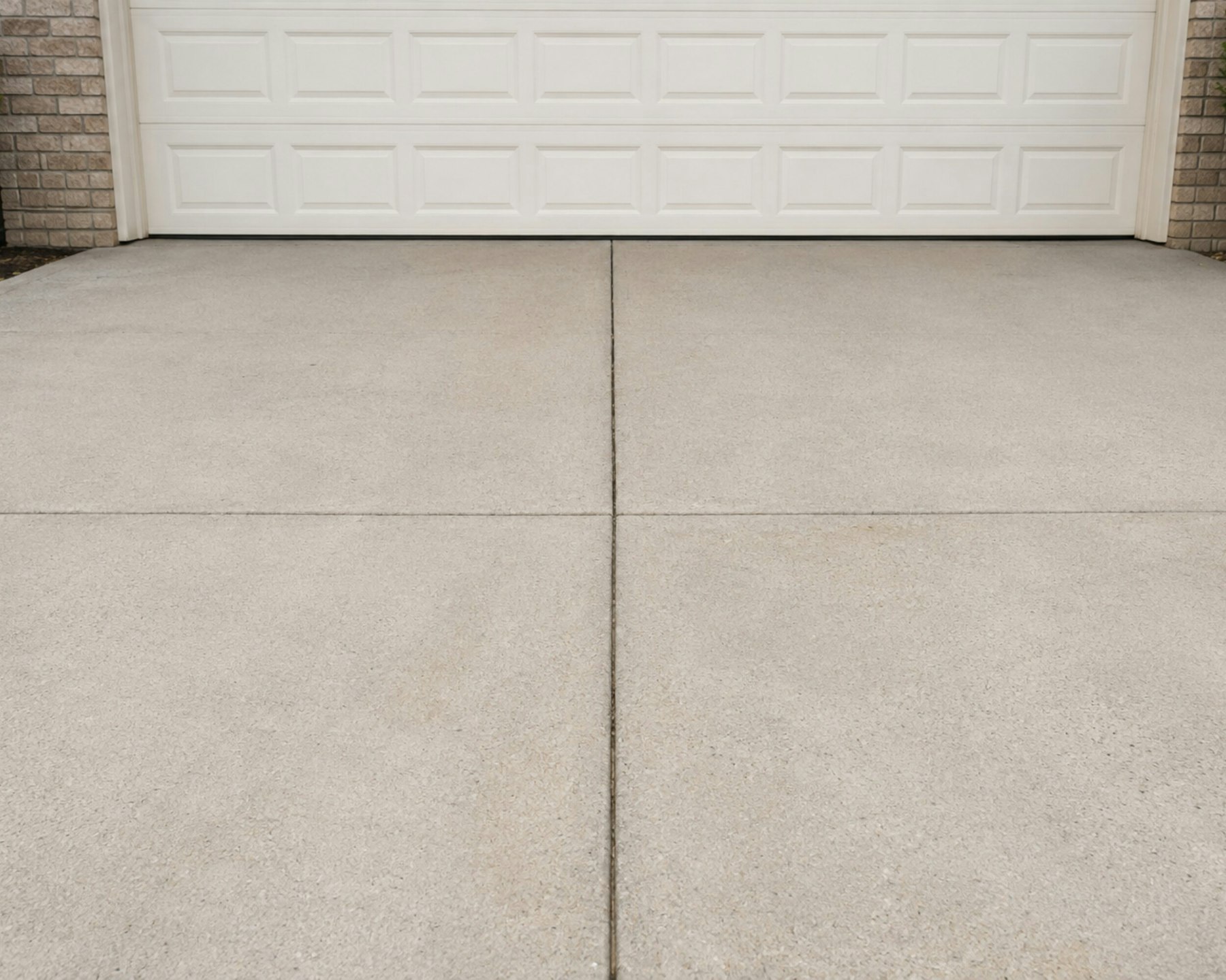 Finished, cured concrete driveway with clean control joints