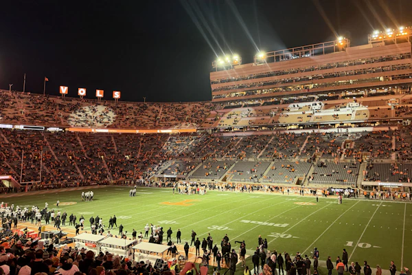 A packed football stadium at night