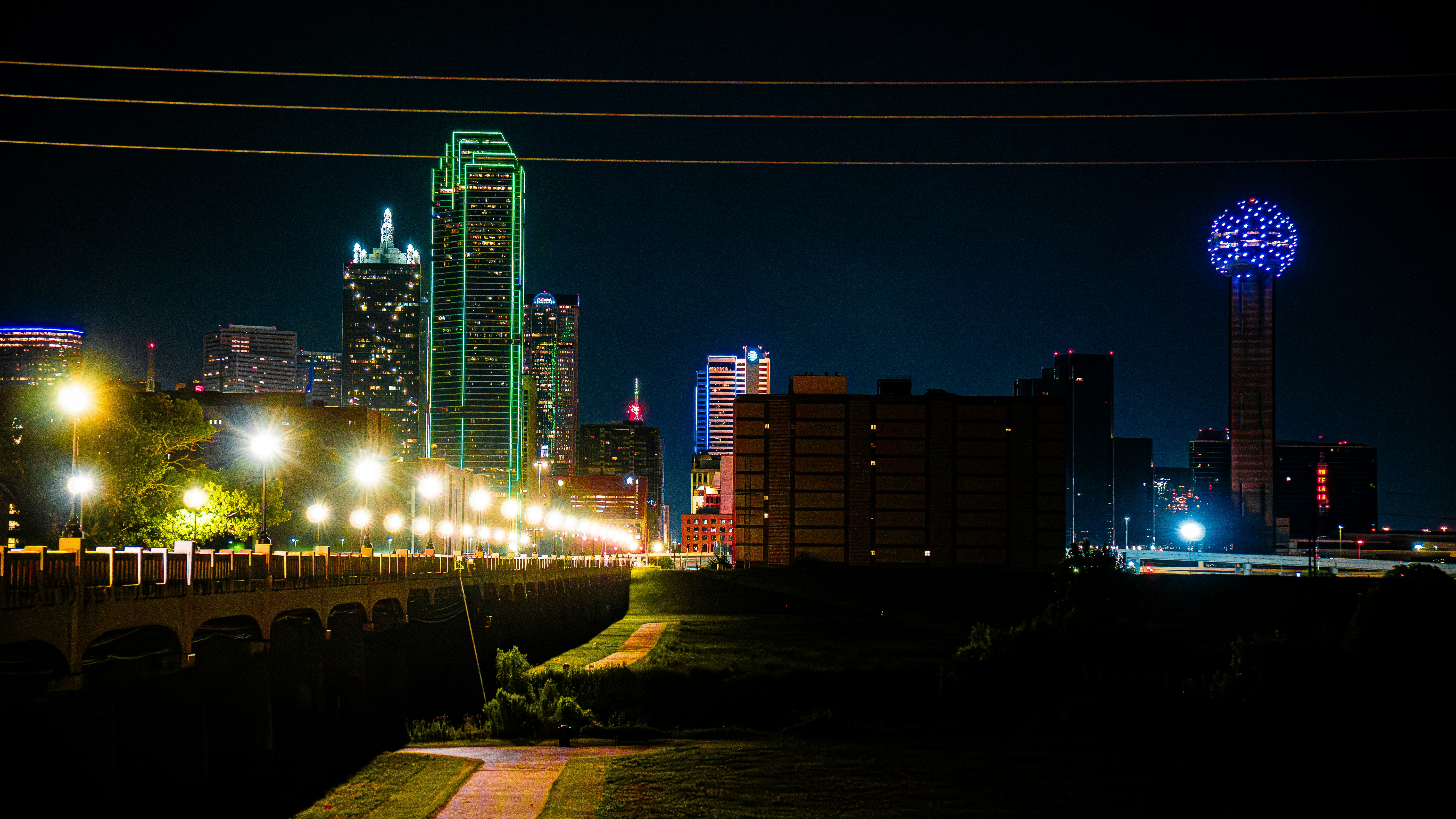 Vibrant dallas city skyline illuminated at night.