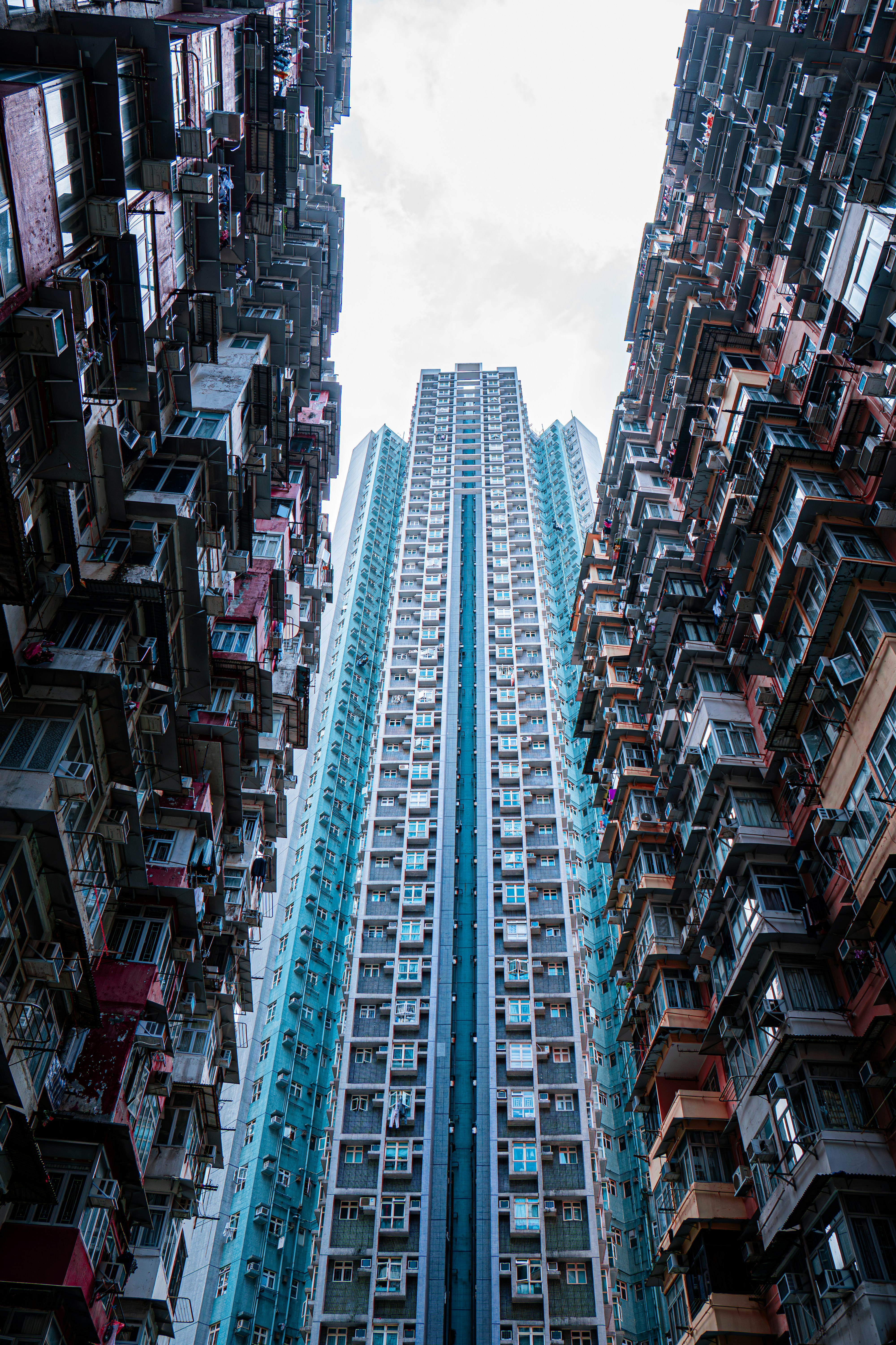 Tall, densely packed residential buildings frame a modern skyscraper.