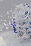 Abstract blue profile disintegrating into white geometric particles.