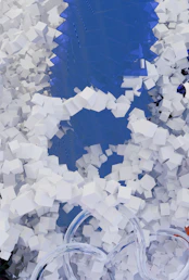 Abstract blue background with scattered white cubes and clear tubes.