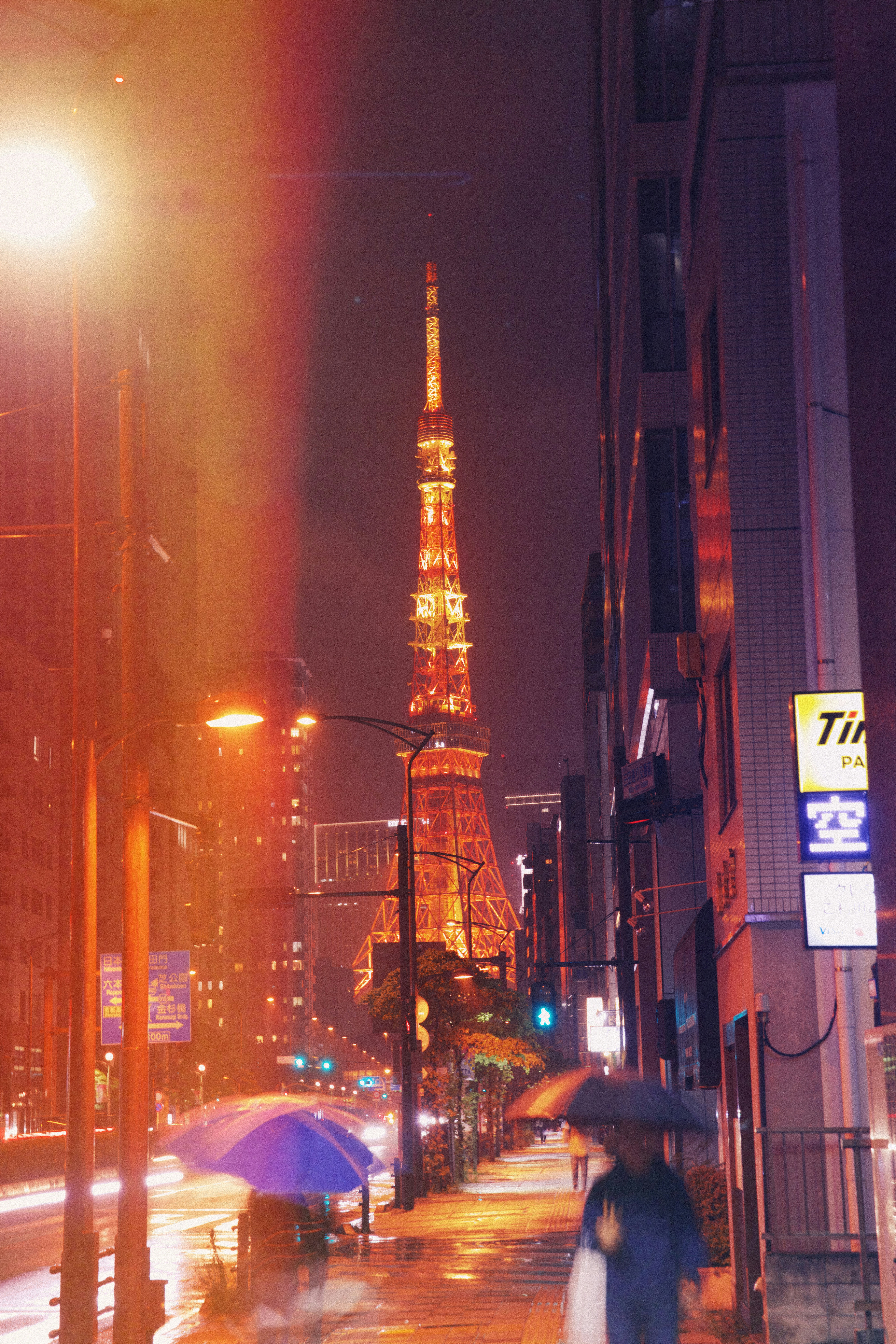 Rainy night in tokyo with the iconic illuminated tower.