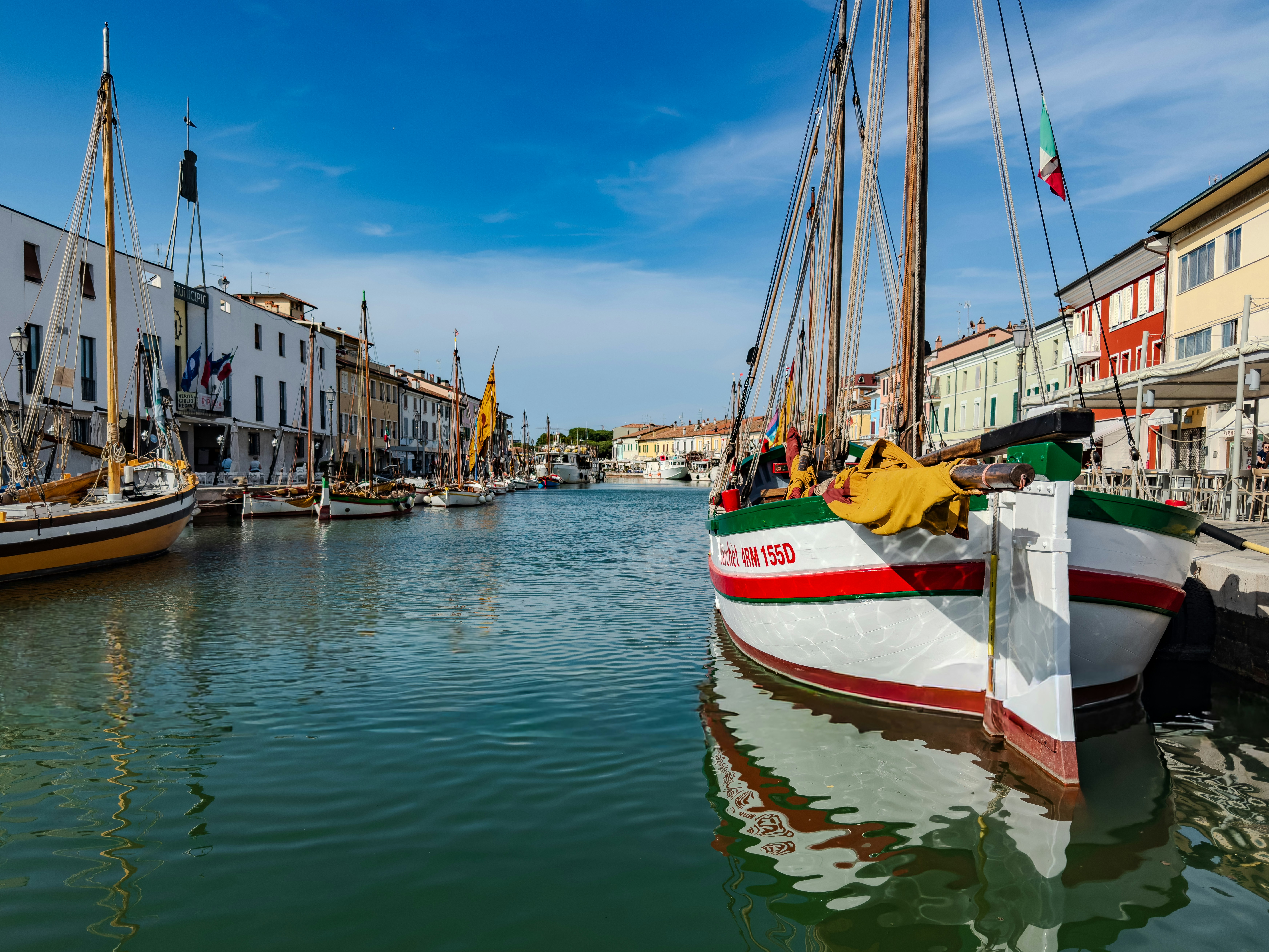 Traditional boats docked in a canal lined with colorful buildings.