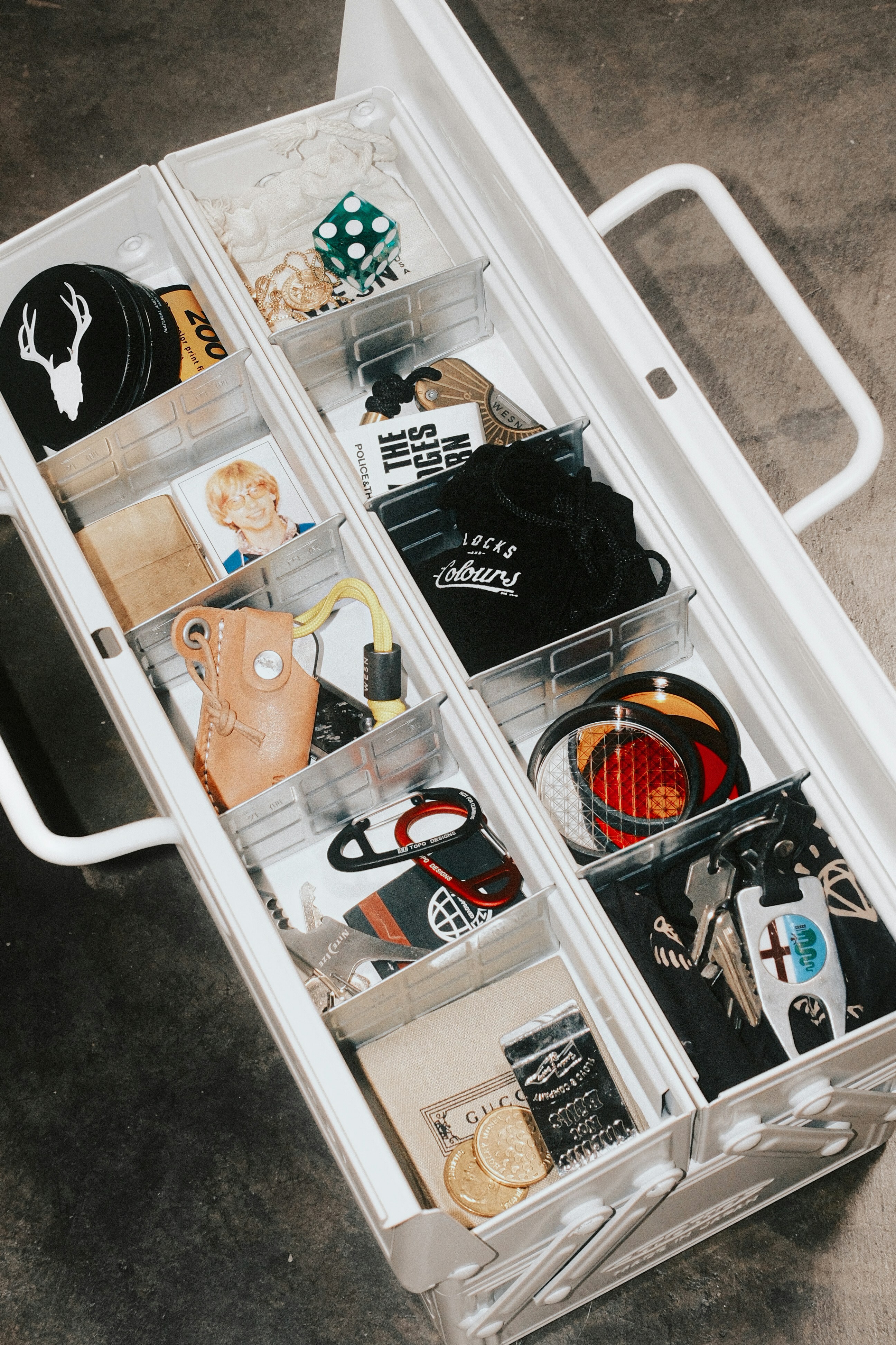 Various small items neatly organized in a white drawer.