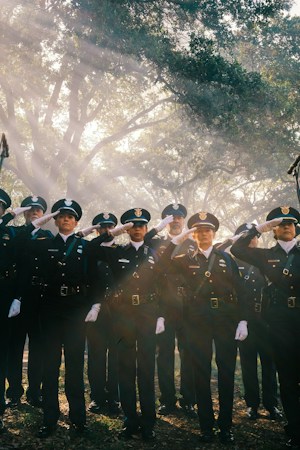Uniformed police officers standing in formation outdoors, the kind of career path students in the Basic Academy law enforcement course learn about