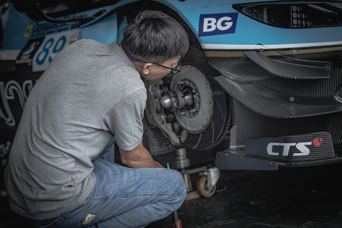 Professional mobile mechanic working on a customer vehicle at their home