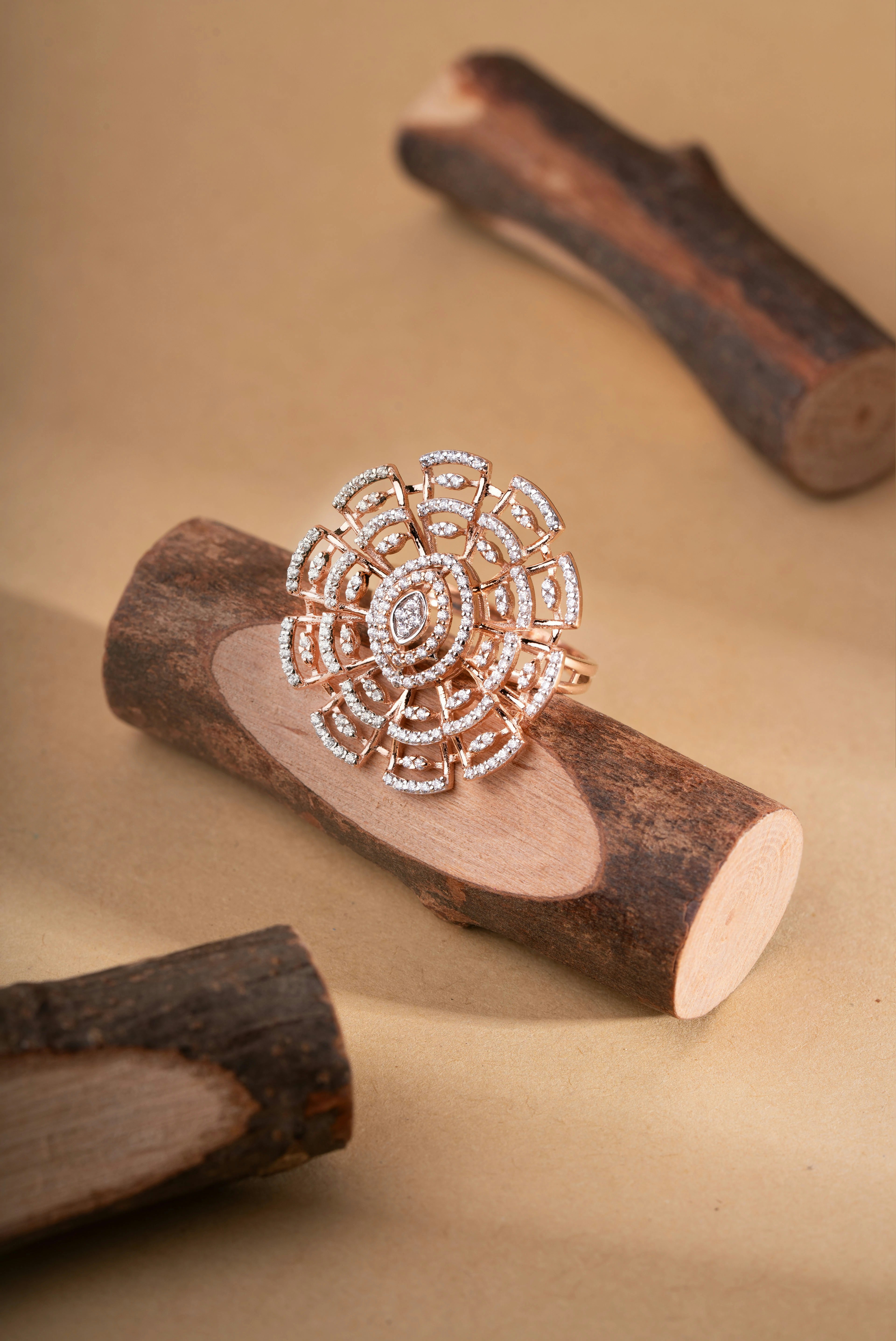 Diamond ring with intricate design on a wooden log.