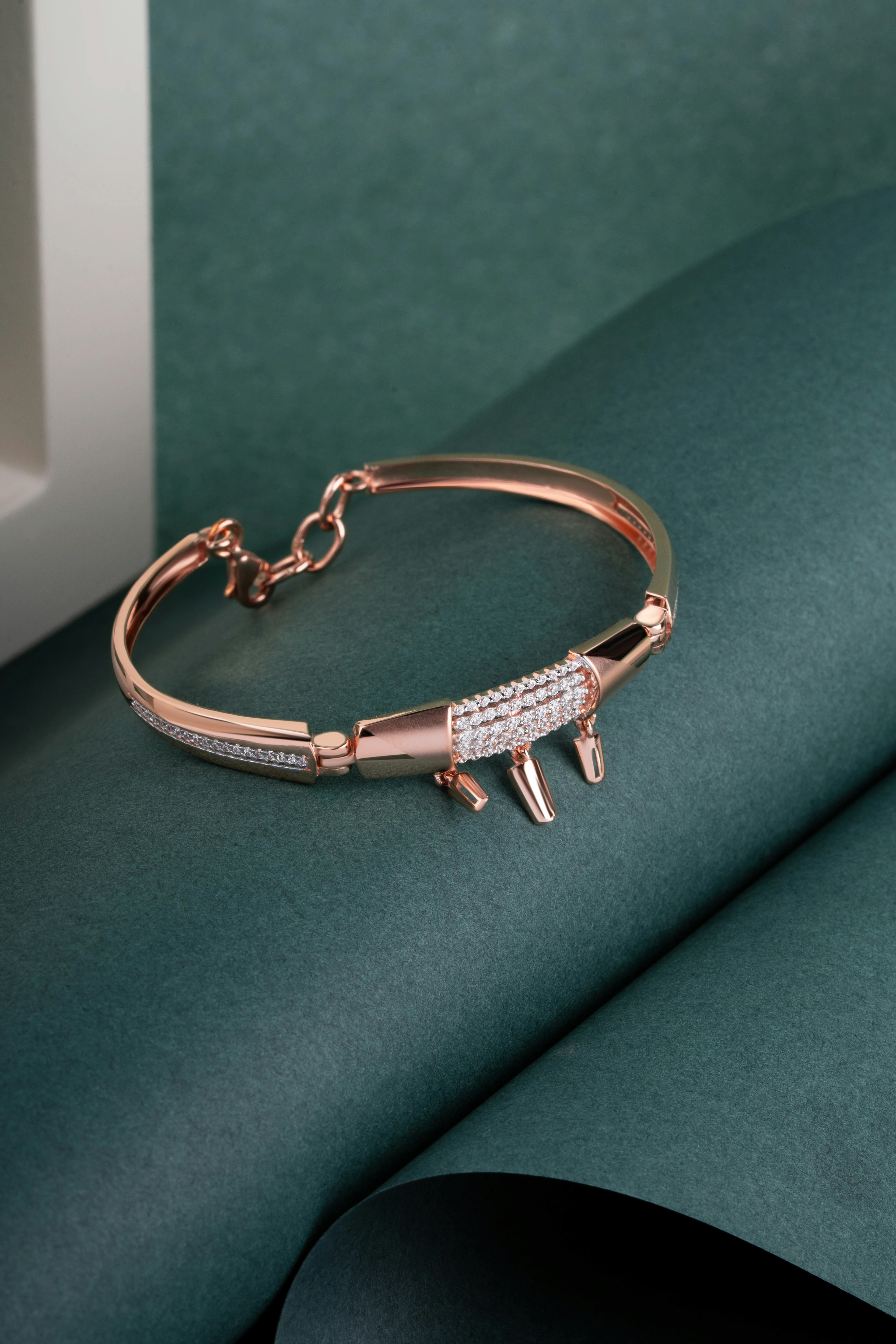 Elegant rose gold crocodile bracelet with white stones.
