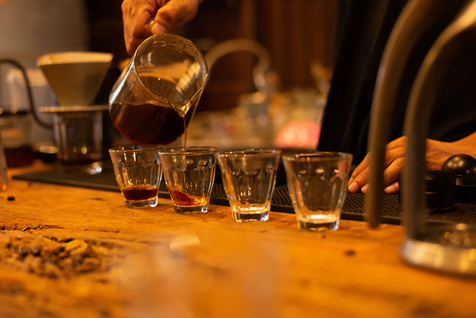 Freshly brewed coffee being poured from a glass carafe