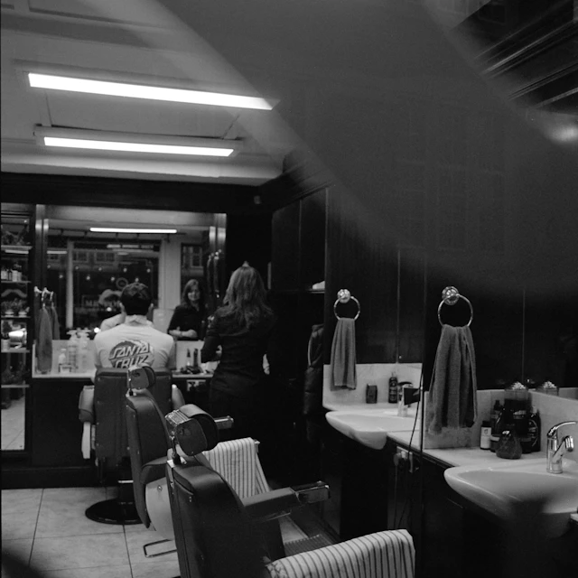 Classic barbershop interior with customers getting haircuts