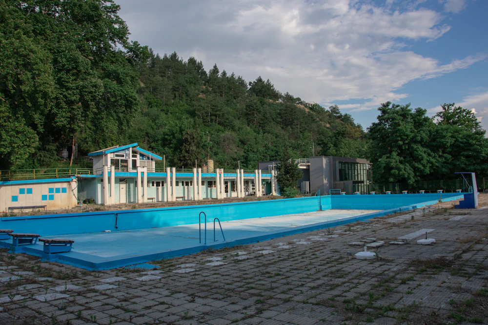 Pool with a green hillside backdrop