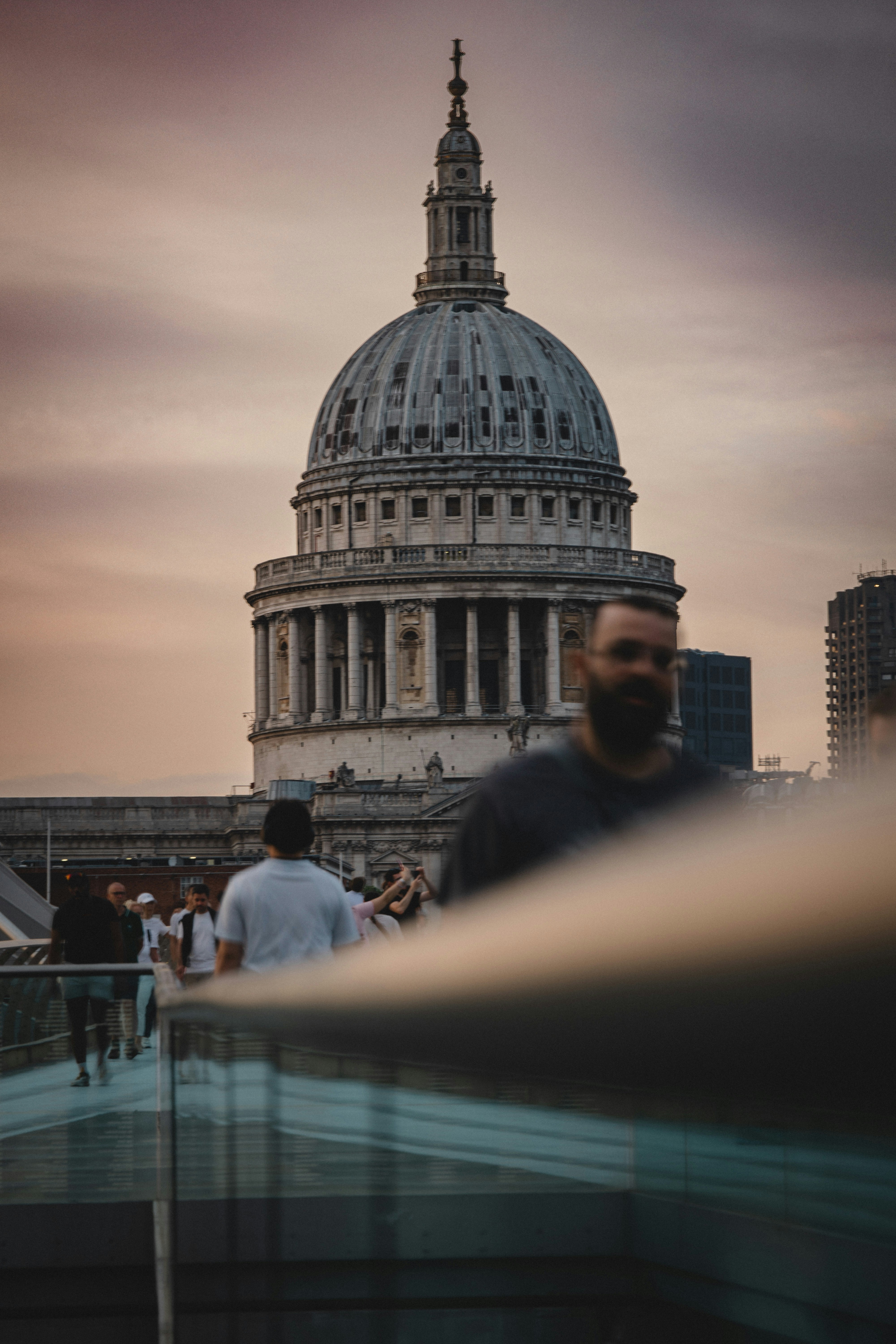 St. paul's cathedral dome behind pedestrians on bridge